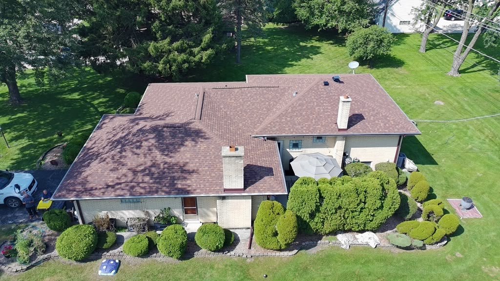 Completed Eagle Star roof in weathered-wood shingles on a large brick home