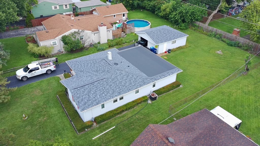 Completed Eagle Star roof on a white ranch home with the crew truck on site